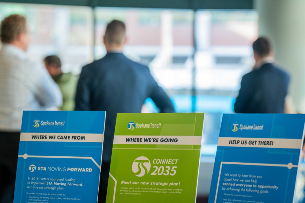 An open meeting, with pamphlets for STA Moving Forward and Connect 2035 in the foreground.